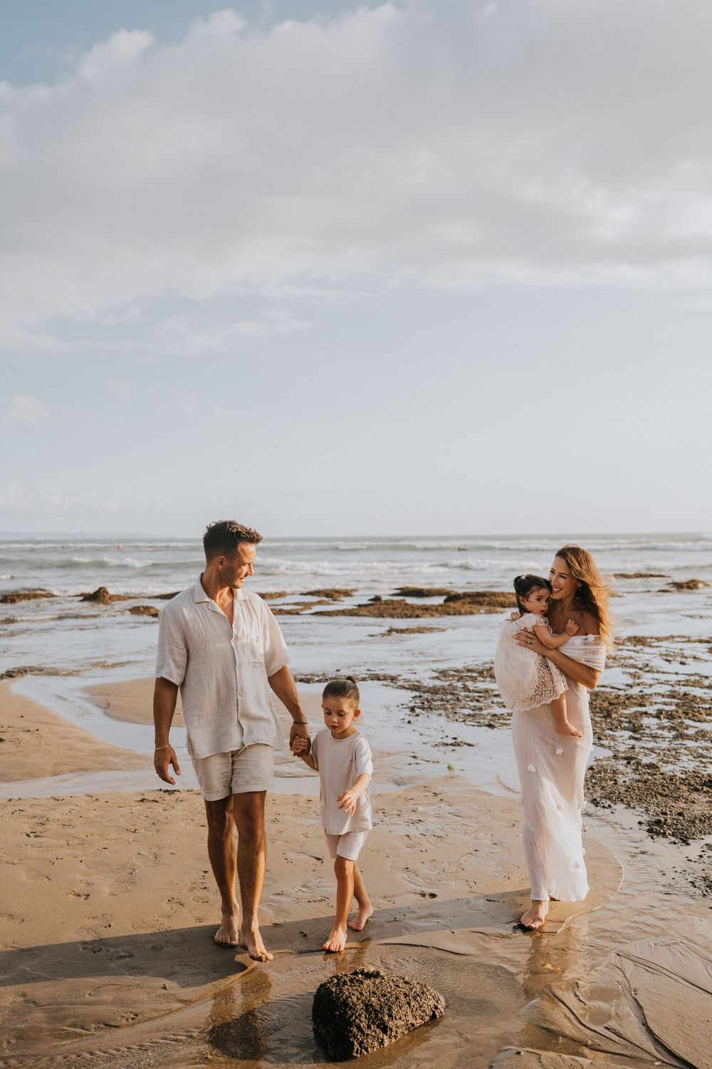 Beach family photography in Bali with an 
ocean backdrop