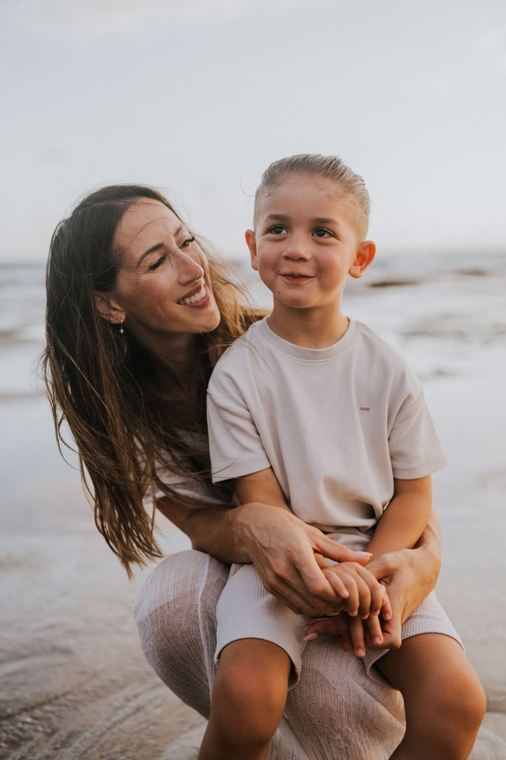 Beach family photography in Bali with an 
ocean backdrop