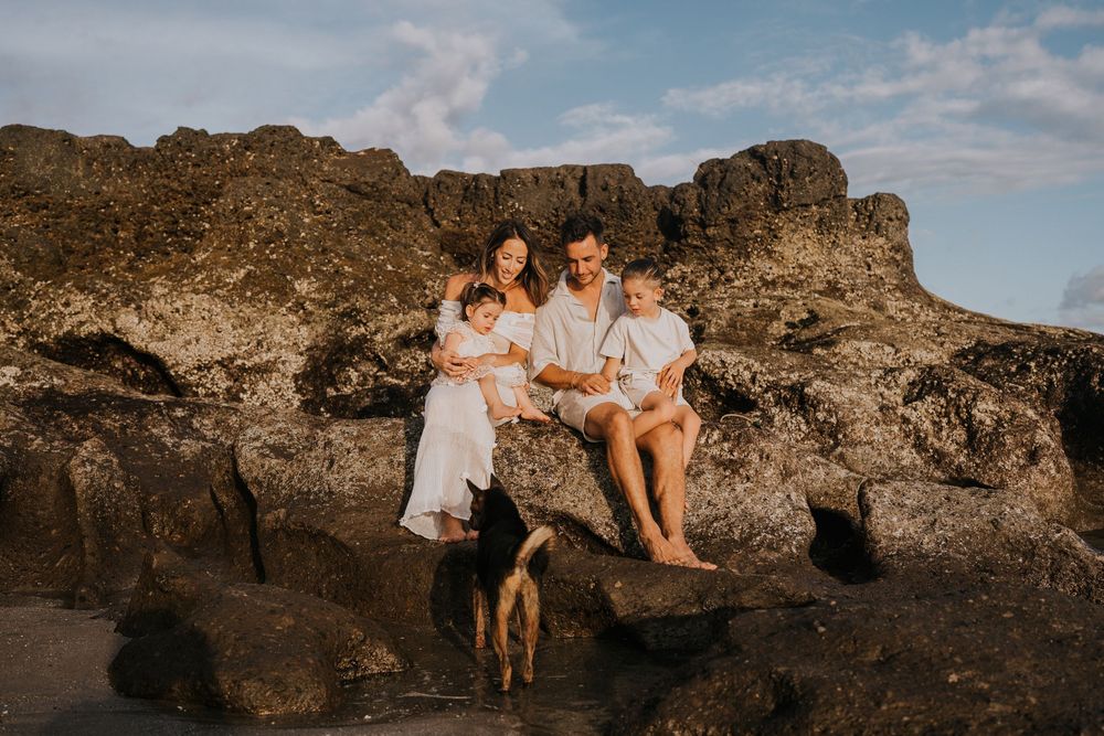 Beach family photography in Bali with an 
ocean backdrop