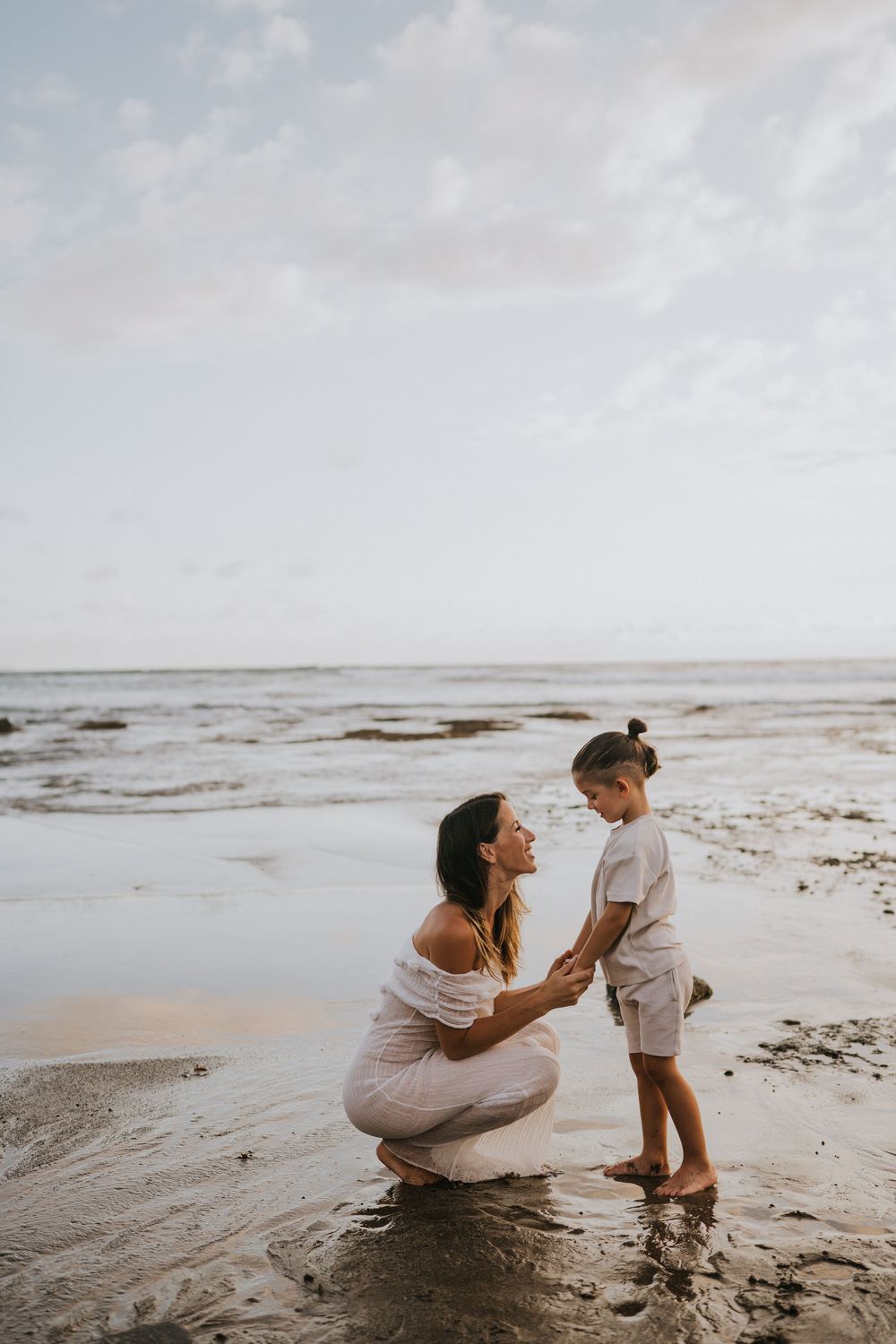 Beach family photography in Bali with an 
ocean backdrop