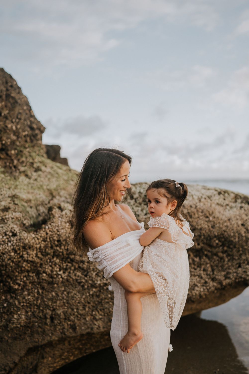 Beach family photography in Bali with an 
ocean backdrop