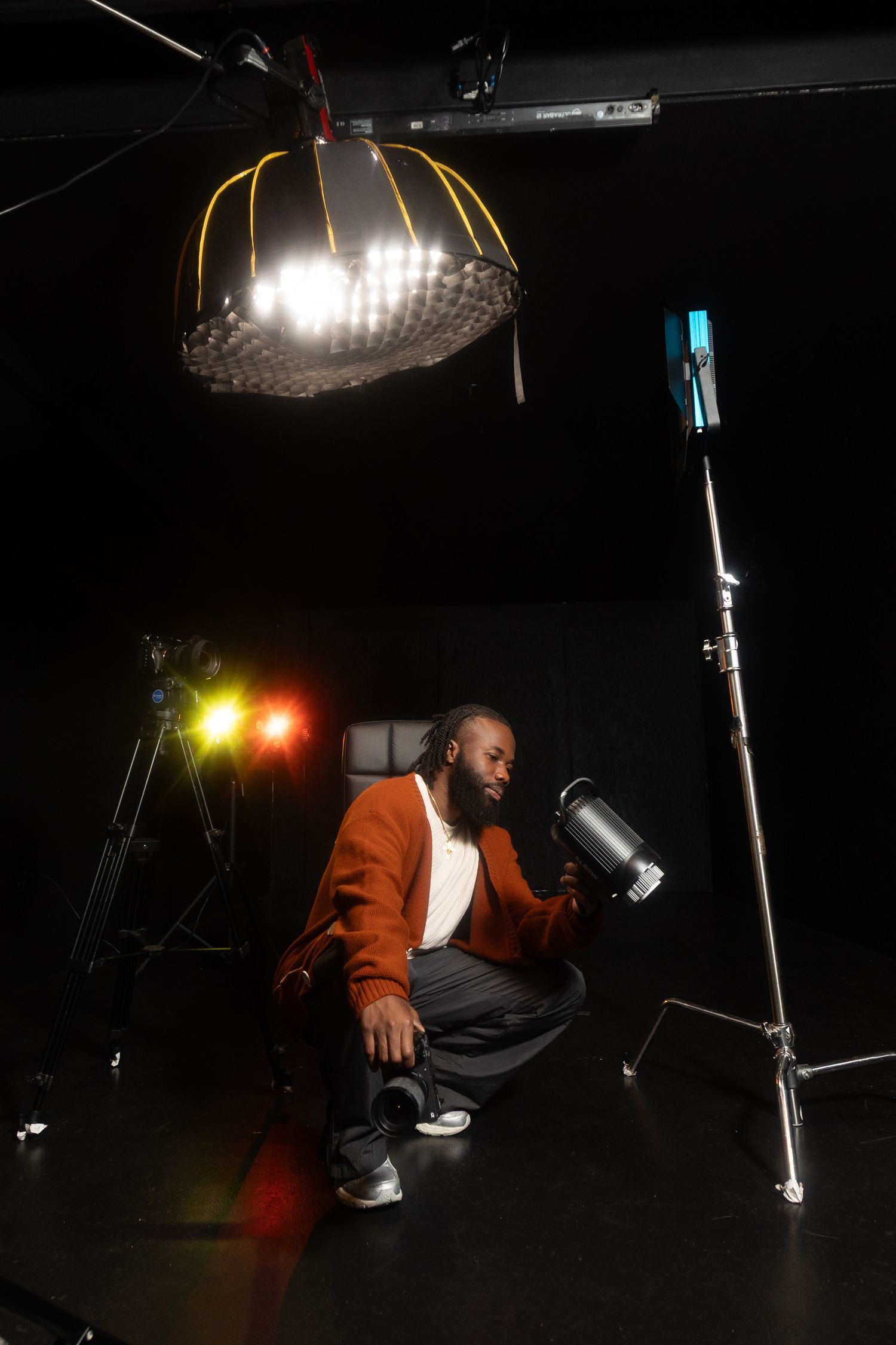 Professional video camera setup in dark room with monitor display.