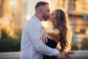 Intimate sunset portrait of couple embracing in formal attire.