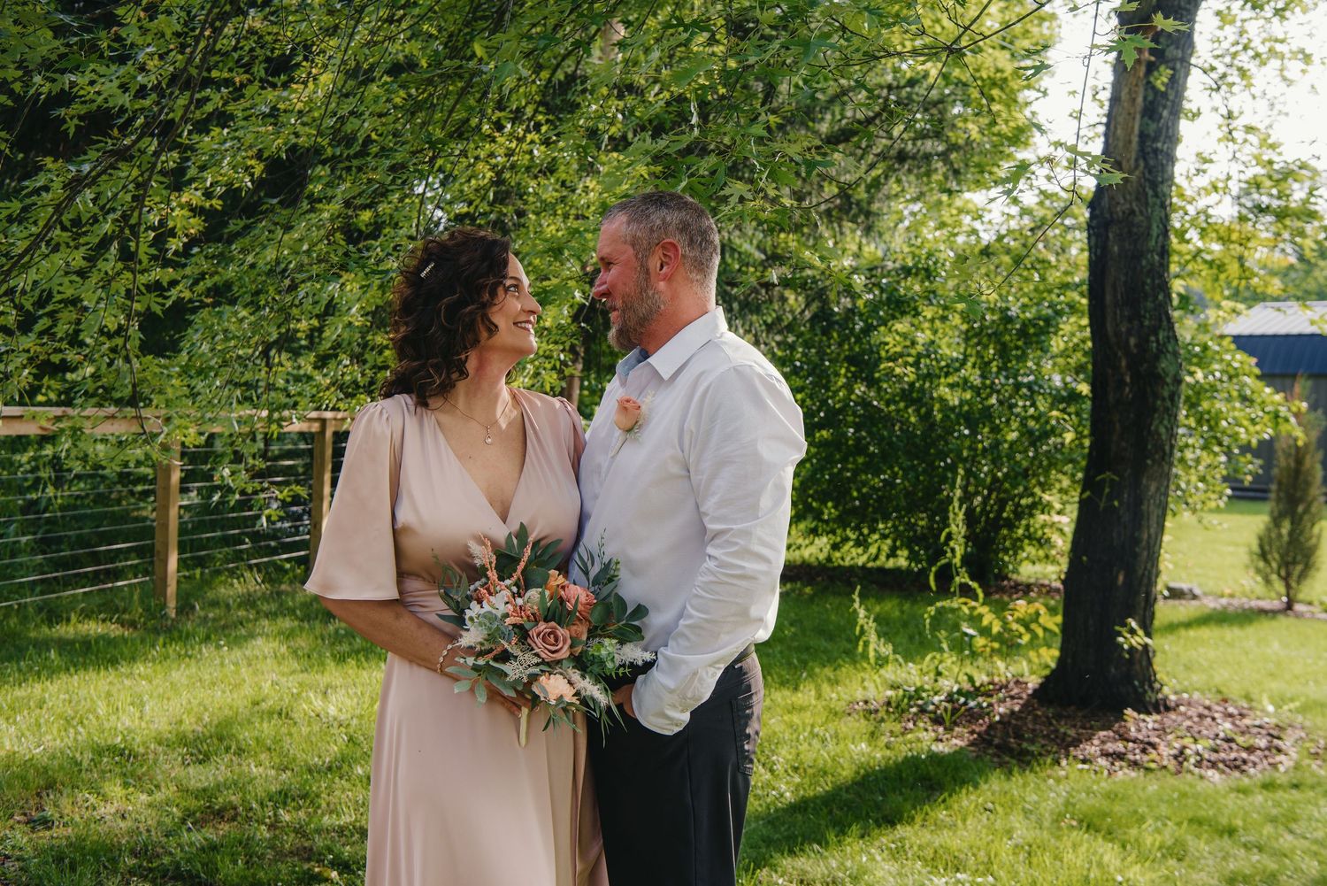 Romantic outdoor wedding photos taken against a backdrop of towering trees at the Appalachian Wedding Chapel.