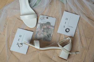 Wedding stationery and invitation details laid out on a light colored surface.