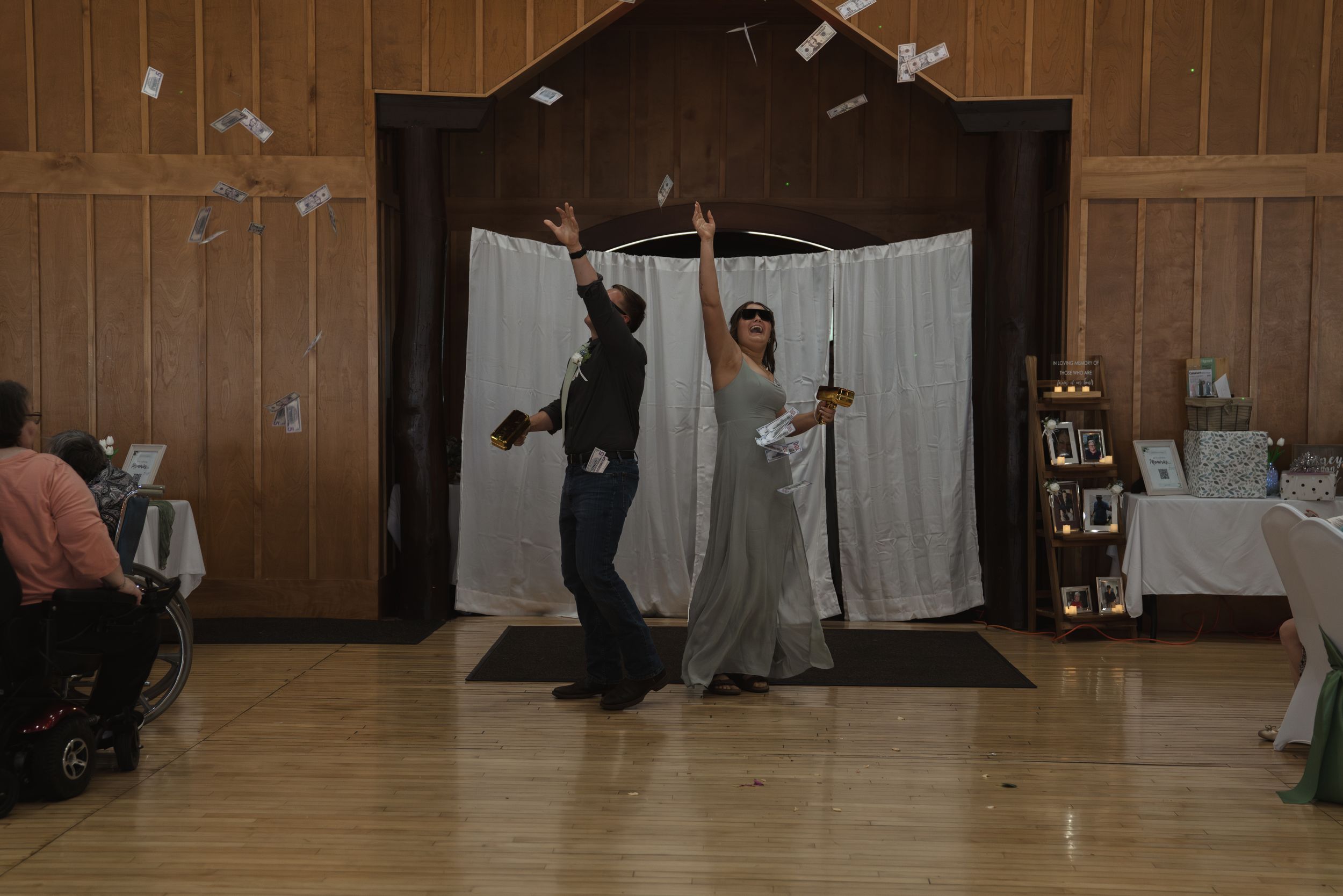 Dark indoor wedding venue with wooden paneled walls and ambient lighting.
