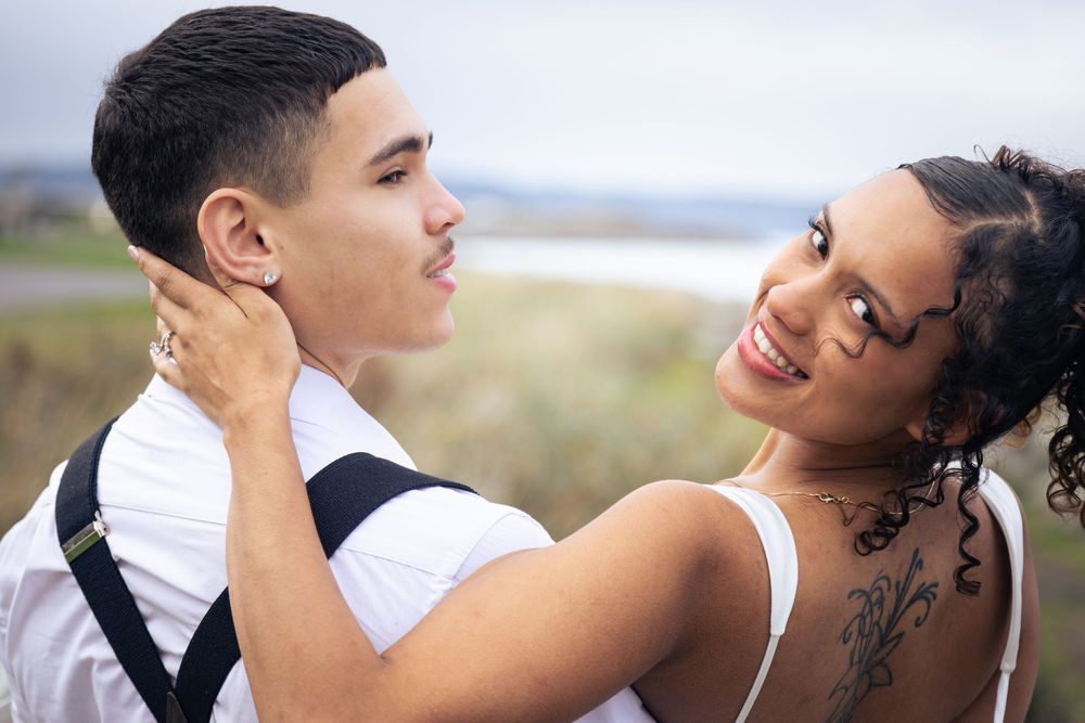 A romantic couple shares tender moments in black and white wedding photos at various outdoor locations.