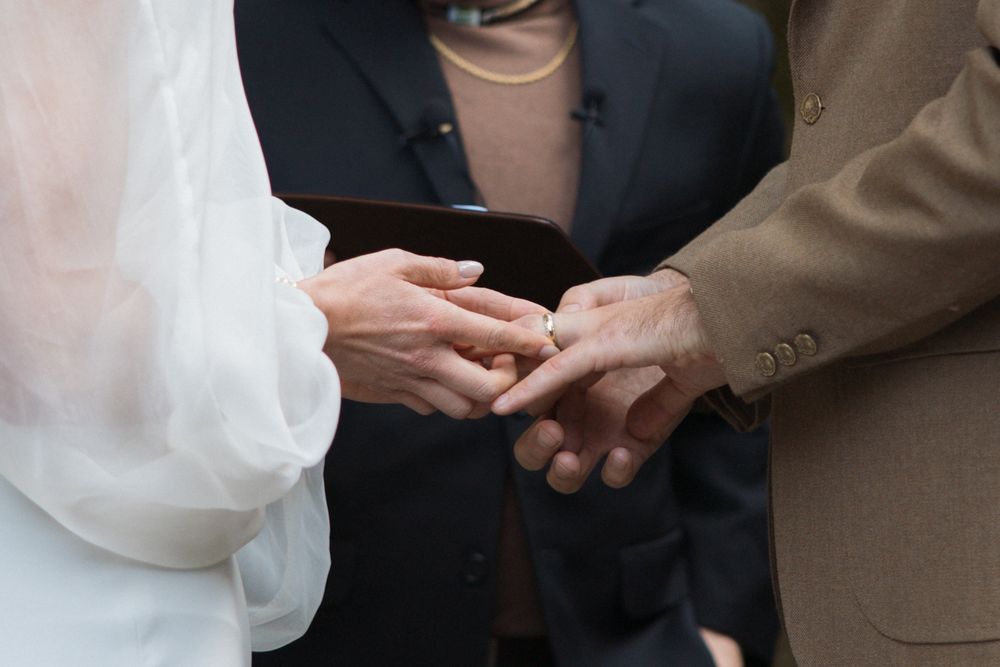 Close-up detail of wedding ring exchange during the ceremony