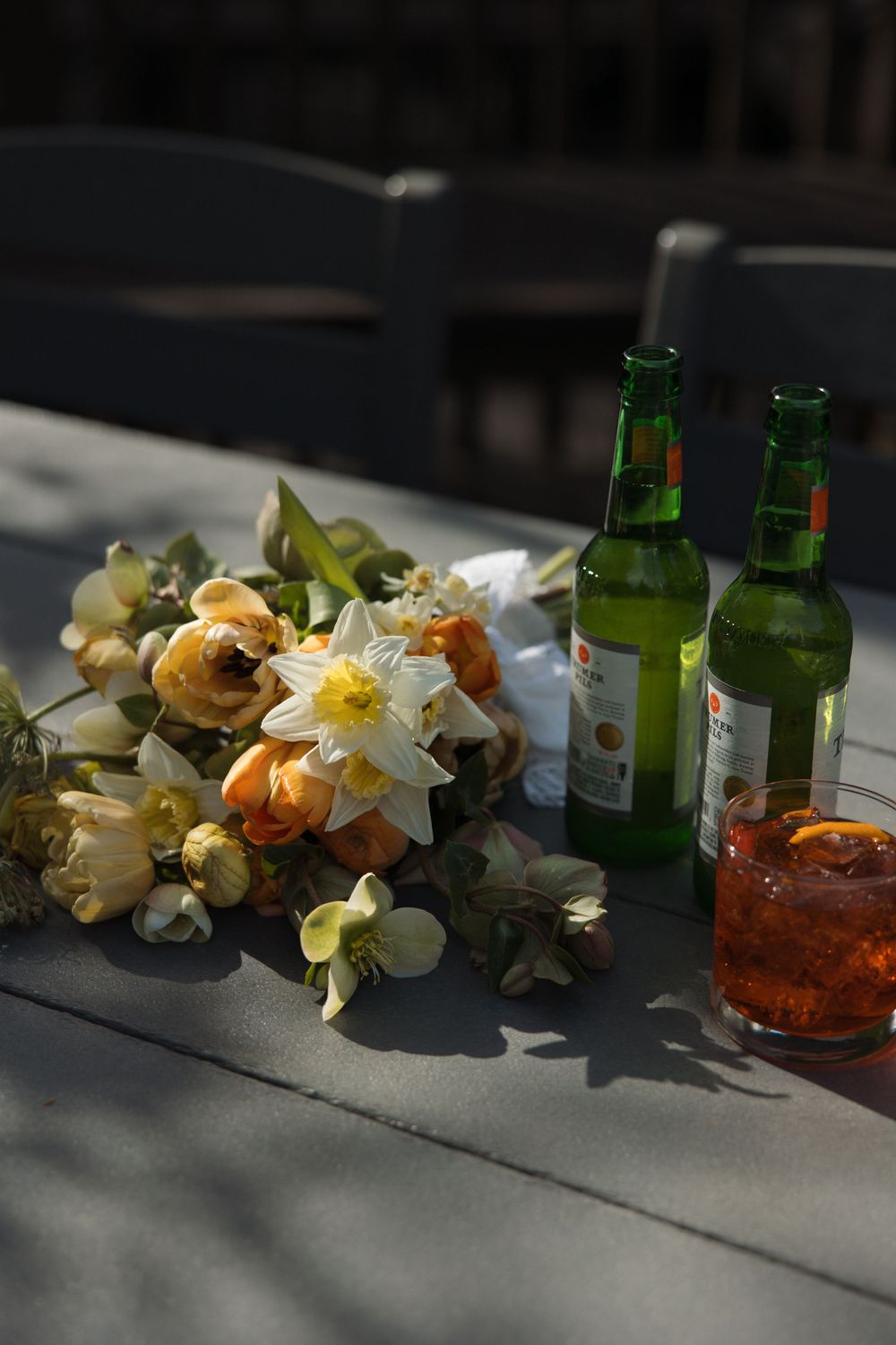 Wedding bouquet styled with beers on a table for a relaxed, candid detail