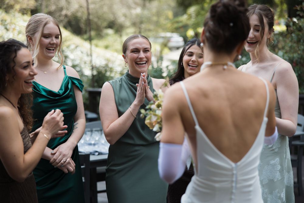Bridesmaids reacting during a first look with the bride at Sand Rock Farm in Aptos, California