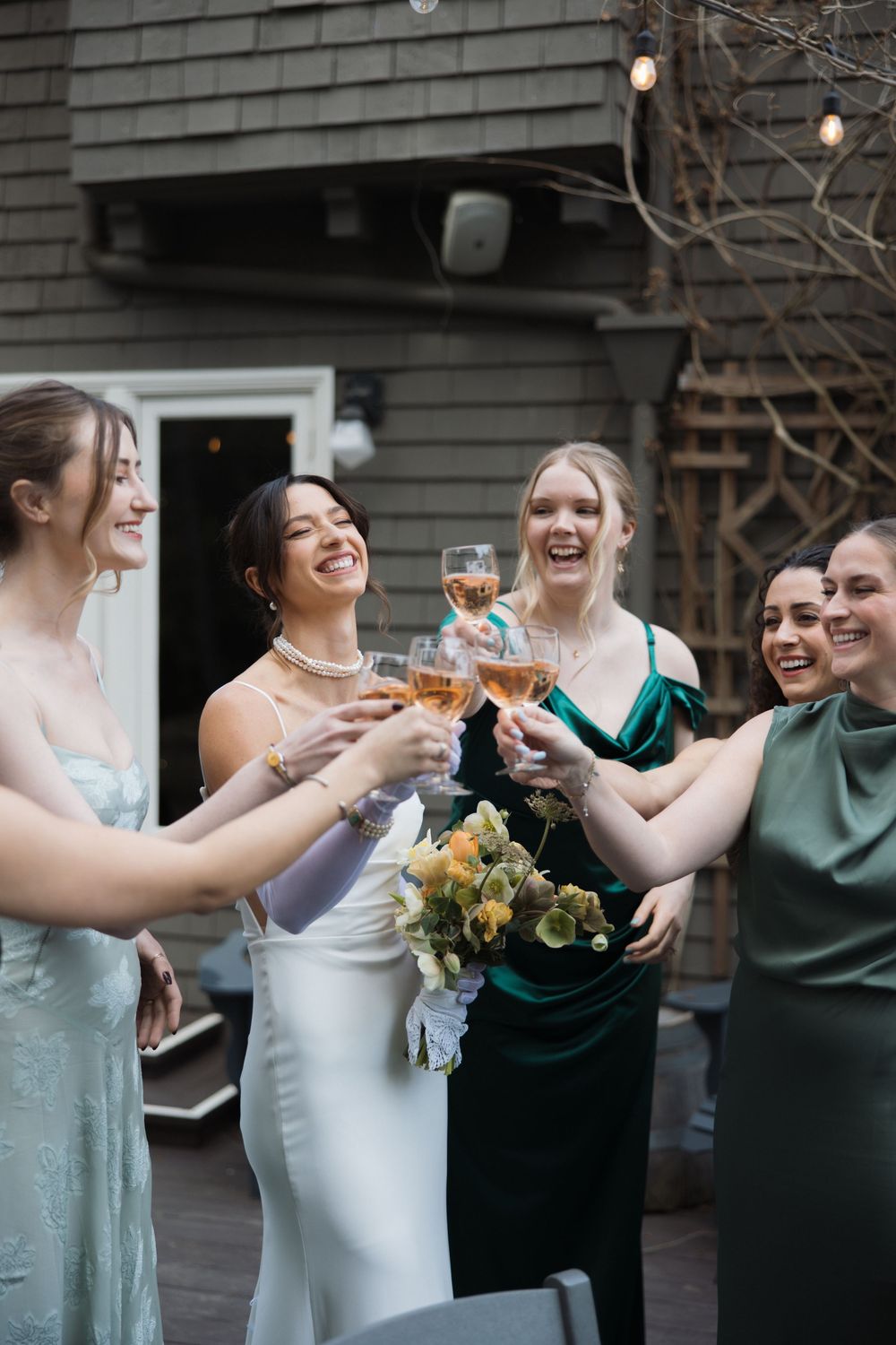 Bride and bridesmaids toasting together during getting ready