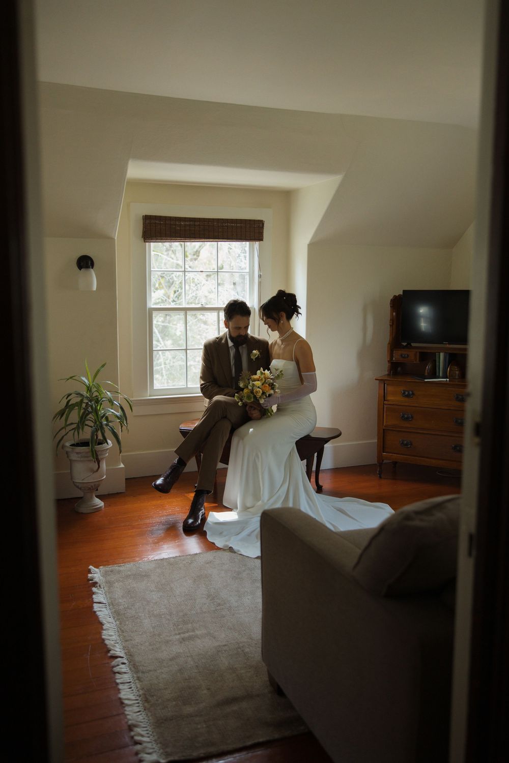 Bride and groom sitting together before their ceremony in a calm, intimate moment