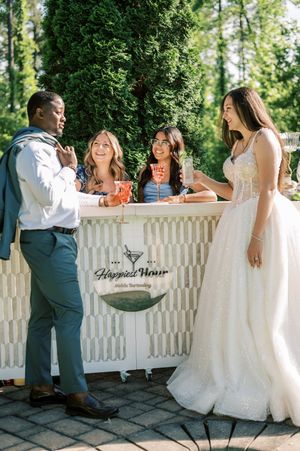 A series of wedding photos showing a couple and guests enjoying beverages on a white picket fence patio.