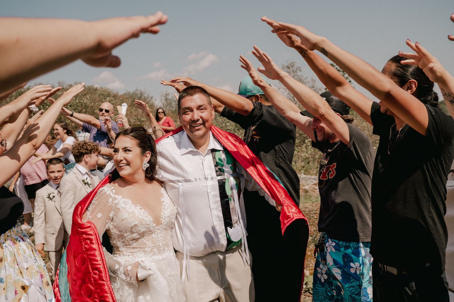 A tender moment shared during a rustic indoor celebration with wooden beams and ceiling fan.