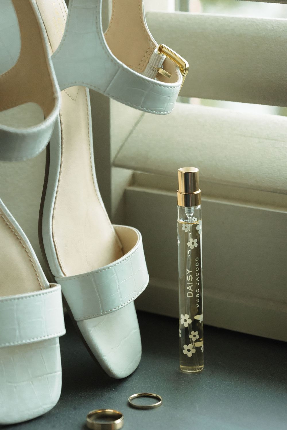 Elegant white bridal heels with clear acrylic heel details shown from different angles in a sequence.