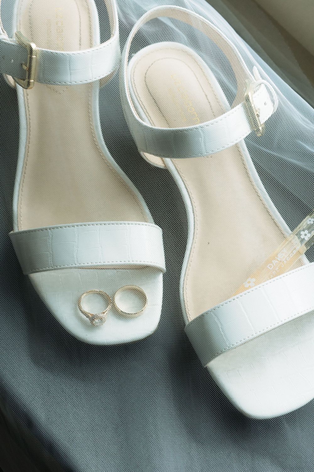 A series of white leather slingback sandals with low heels shown from different angles in similar lighting conditions.