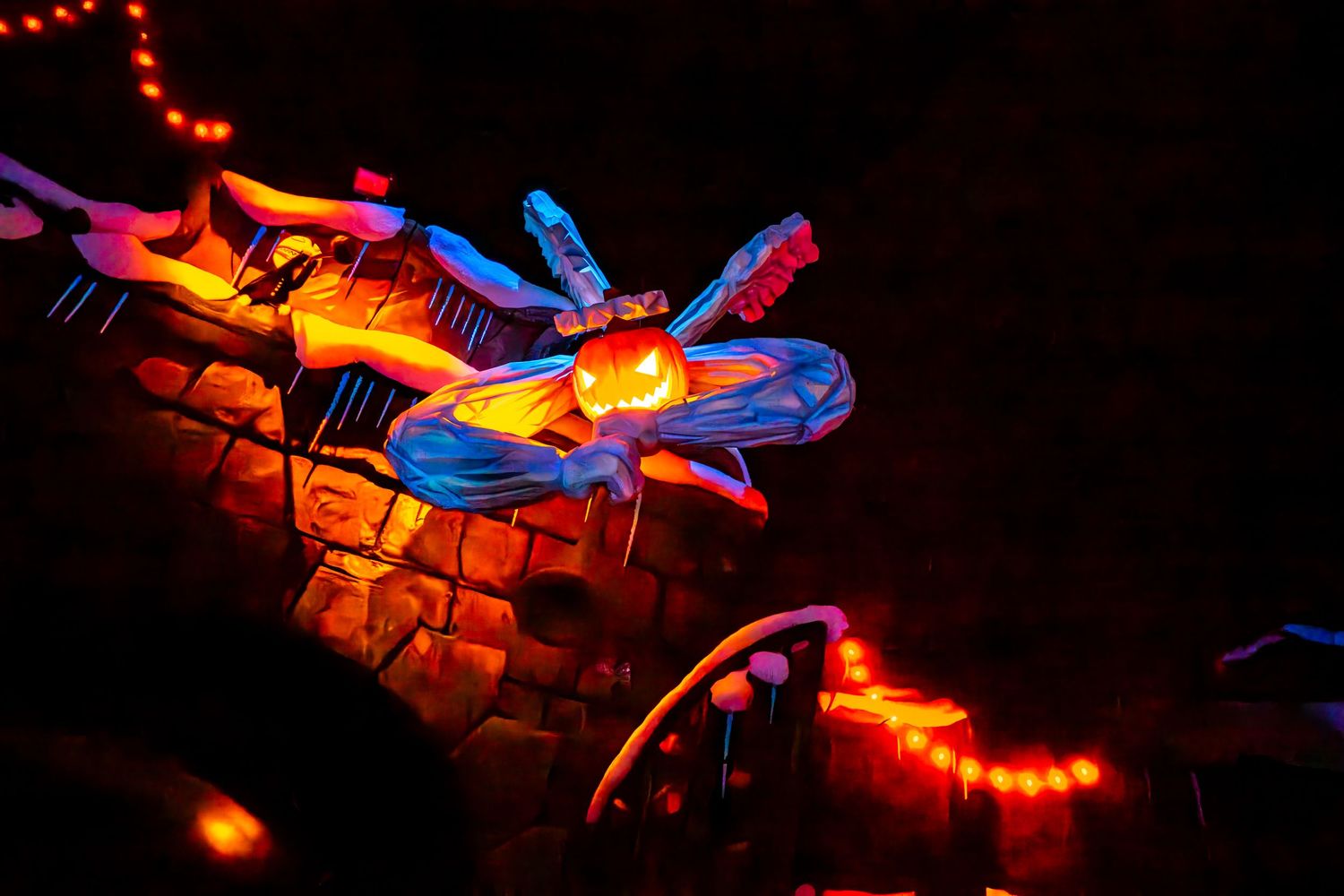 Colorful illuminated dragon lantern display glowing with red and blue lights against dark night sky.