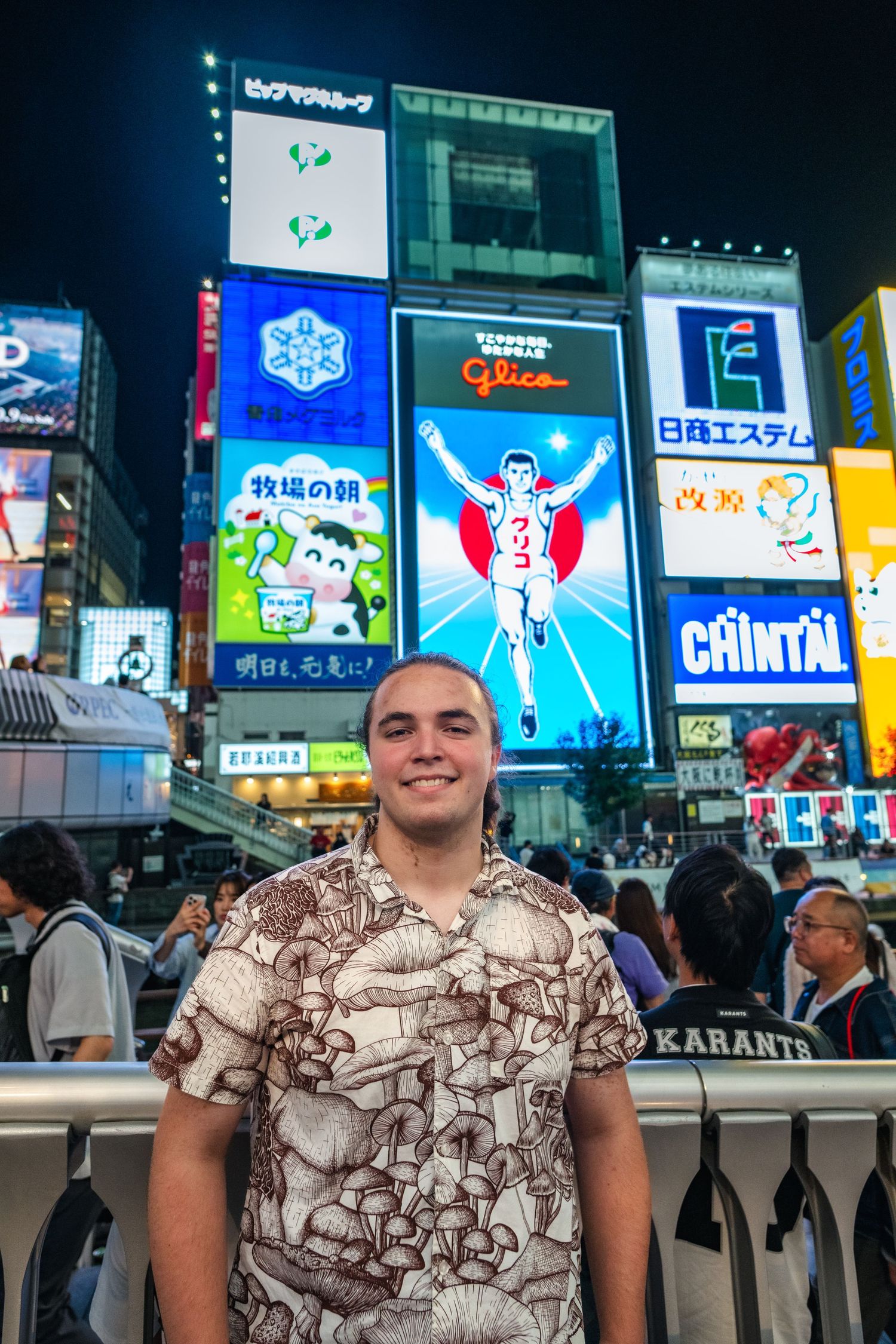 Illuminated billboards and neon signs light up the famous Dotonbori district in Osaka, Japan at night.