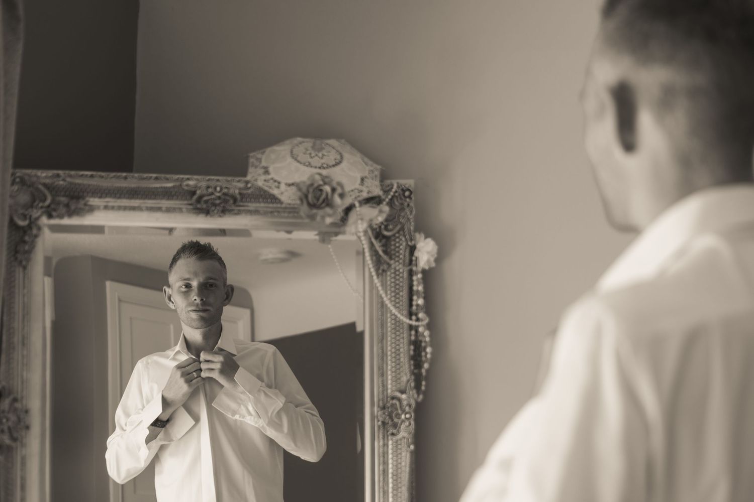 Elegant wedding preparation scene in soft black and white tones.