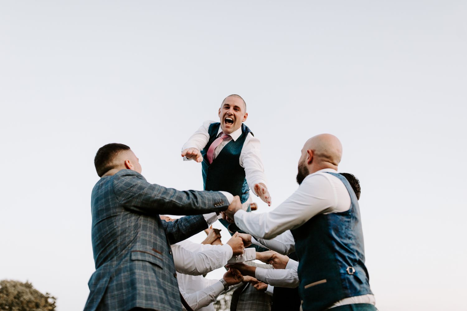 Groom being thrown in the air
