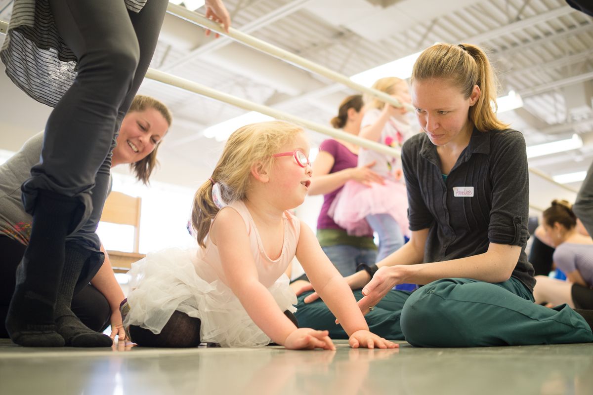Interactive dance workshop with participants engaged in floor exercises.