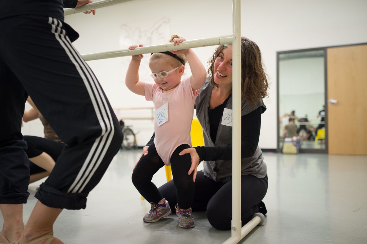 Dance or movement class participants practicing techniques in bright studio space.