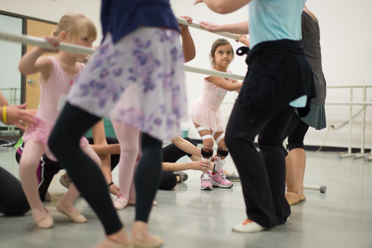 Dance students practice together in a mirrored studio during class.