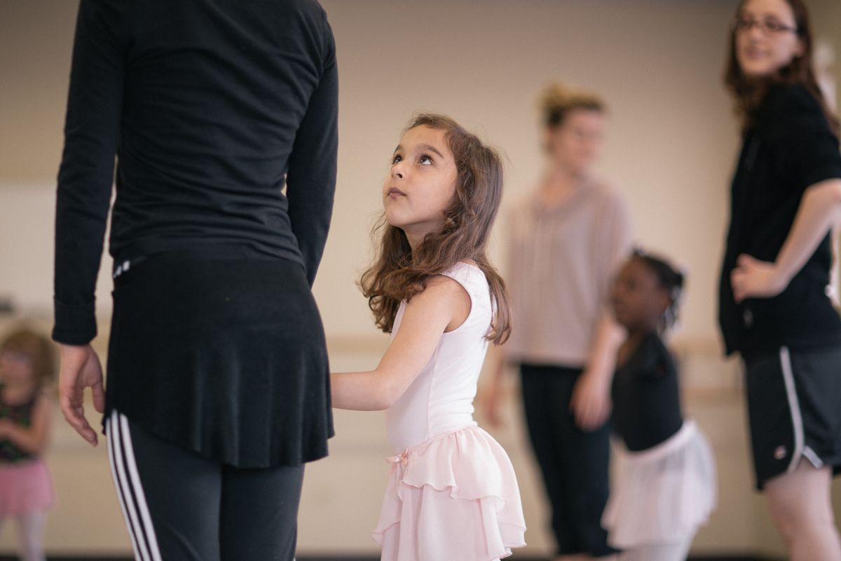 Dance class scene with students in practice attire.