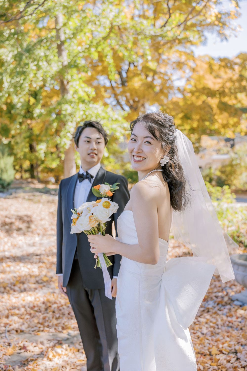 A joyful wedding photo sequence showing candid moments between a couple in fall scenery.