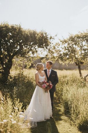 Golden sunlight illuminates a couple during their outdoor wedding photoshoot. Captured by Lincolnshire photographers.