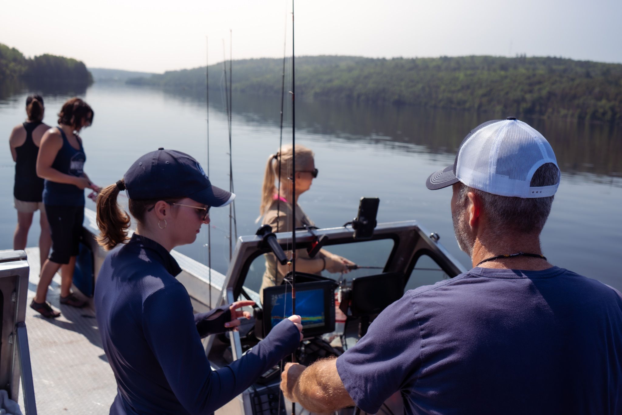 Fishing crew preparing gear and equipment on a boat deck.