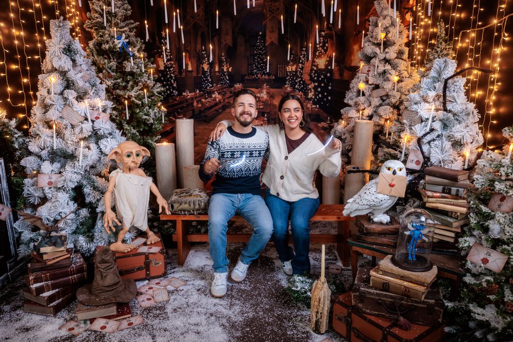 Magical Christmas scene with white trees, hanging lights, and vintage suitcases creating a cozy atmosphere.