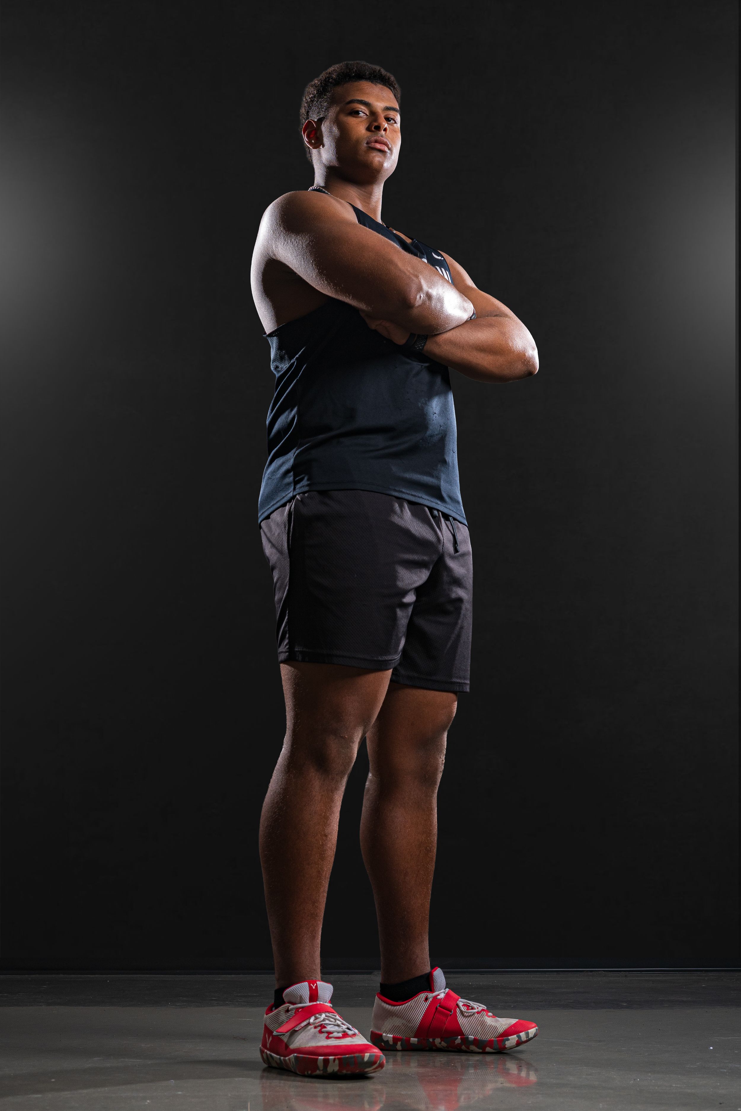 Dynamic Team Media Day photo of an athletic person in uniform and red shoes posing confidently with crossed arms - Warsaw, Indiana
