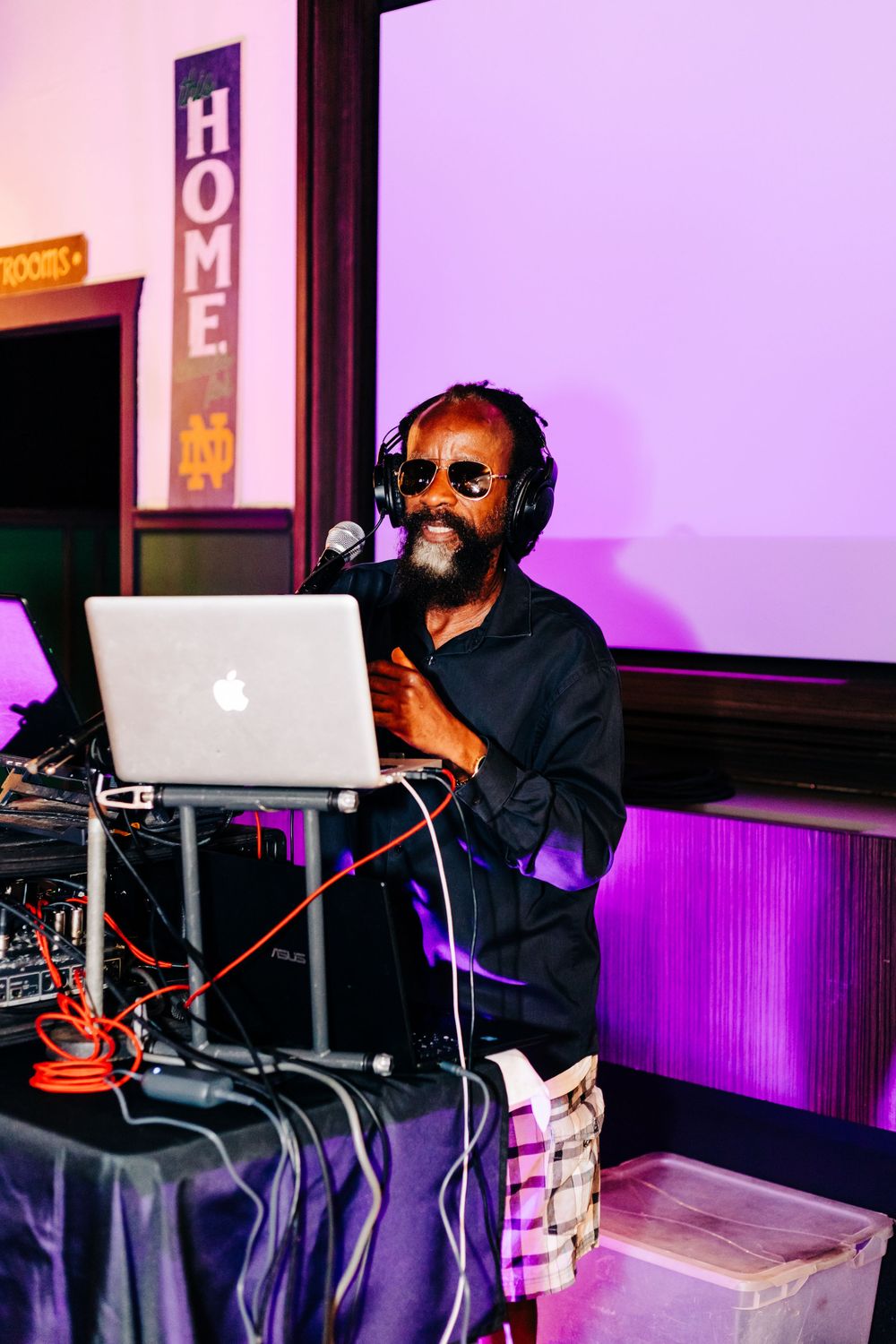 DJ performs with MacBook laptop at an event in lake worth.