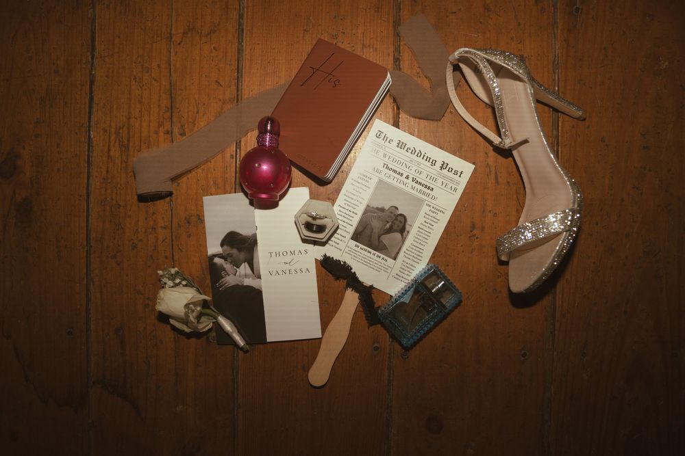 Vintage wedding memorabilia and decorative items arranged on wooden surface.