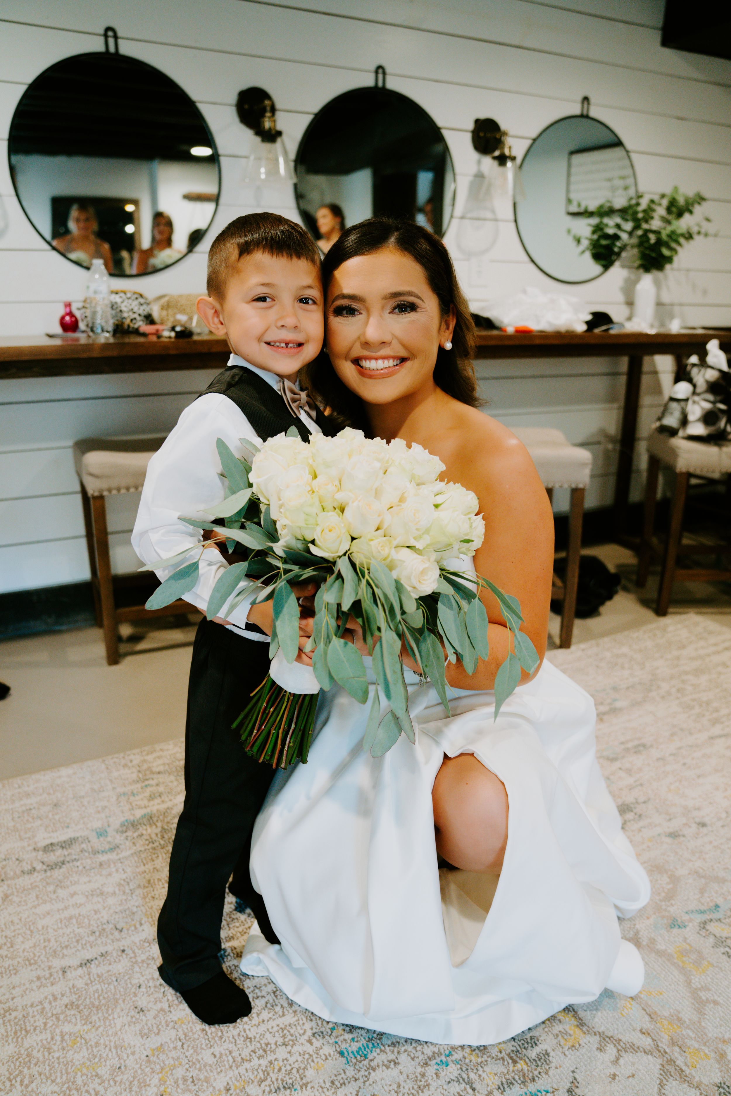 Wedding scene with white floral bouquet and formal attire in bright indoor setting.