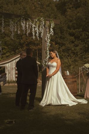 Romantic outdoor wedding ceremony with vintage decor and natural autumn setting.