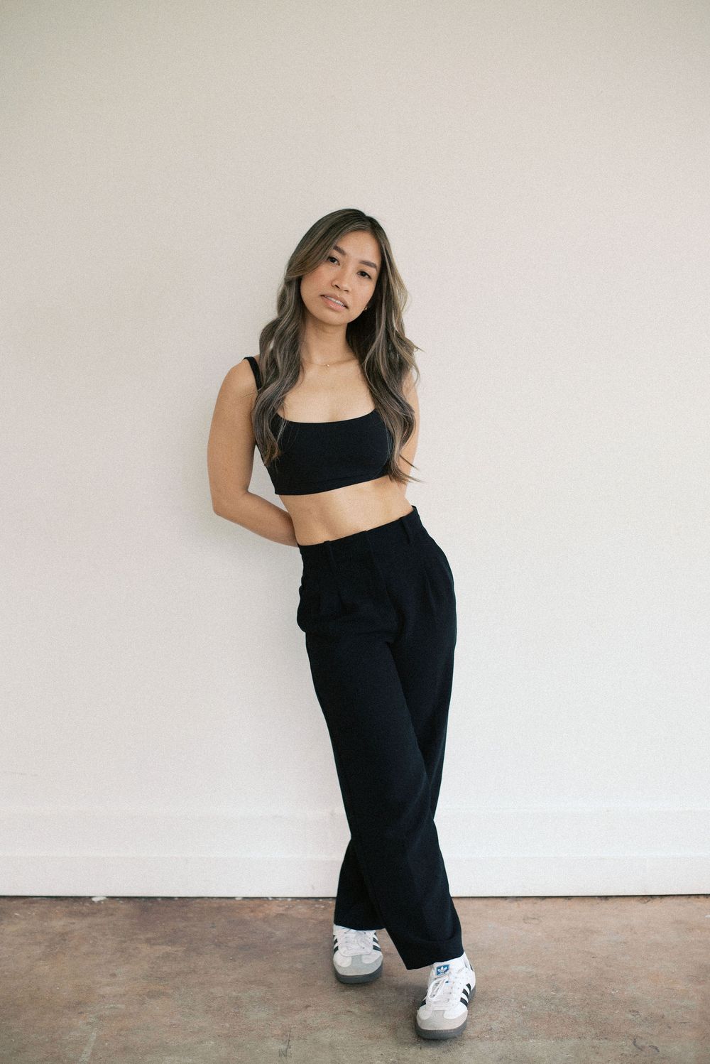 Full length athletic wear fashion photo against minimal white background.