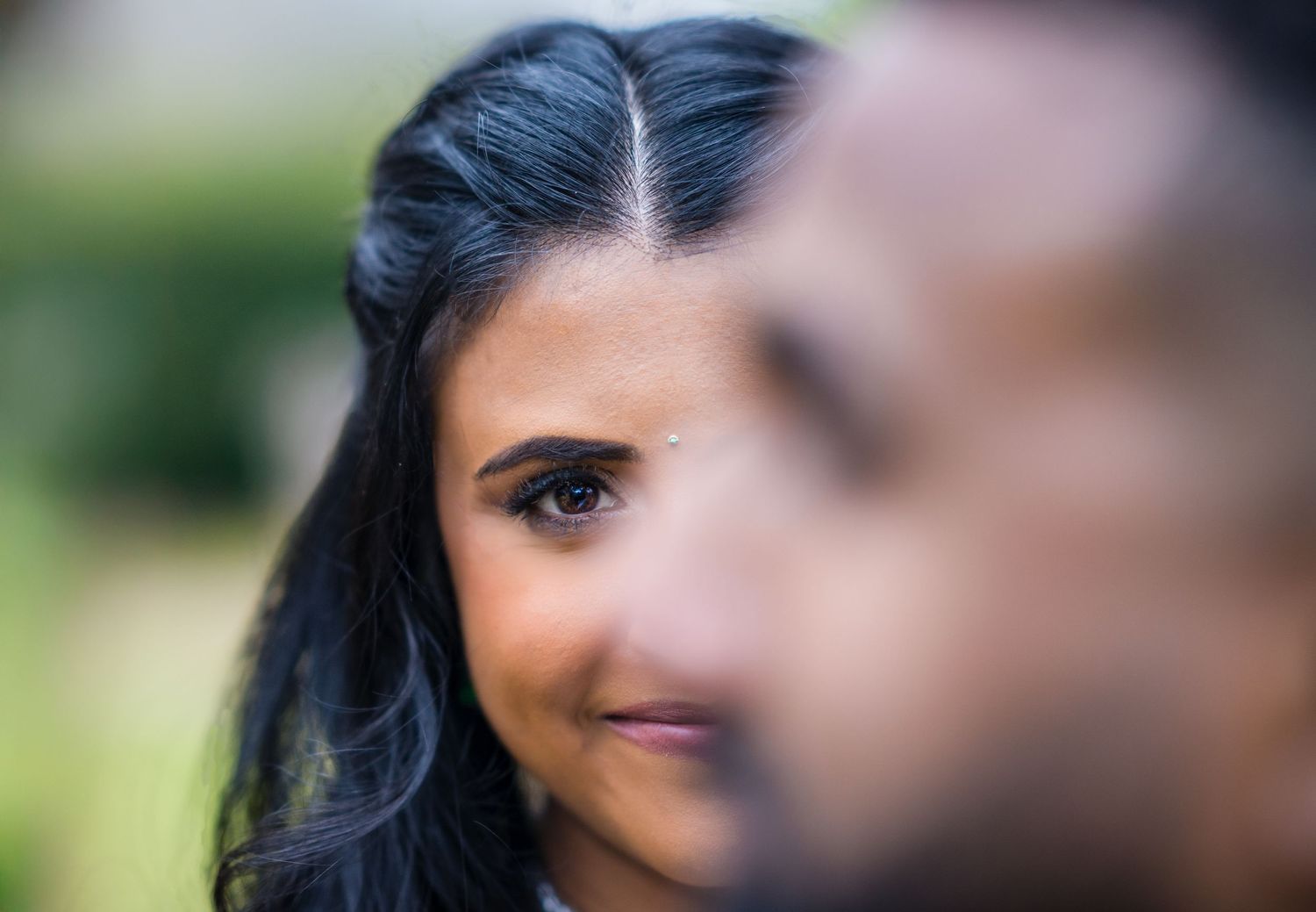 A close-up portrait shot with selective focus creating a partial view against a soft blurred background.