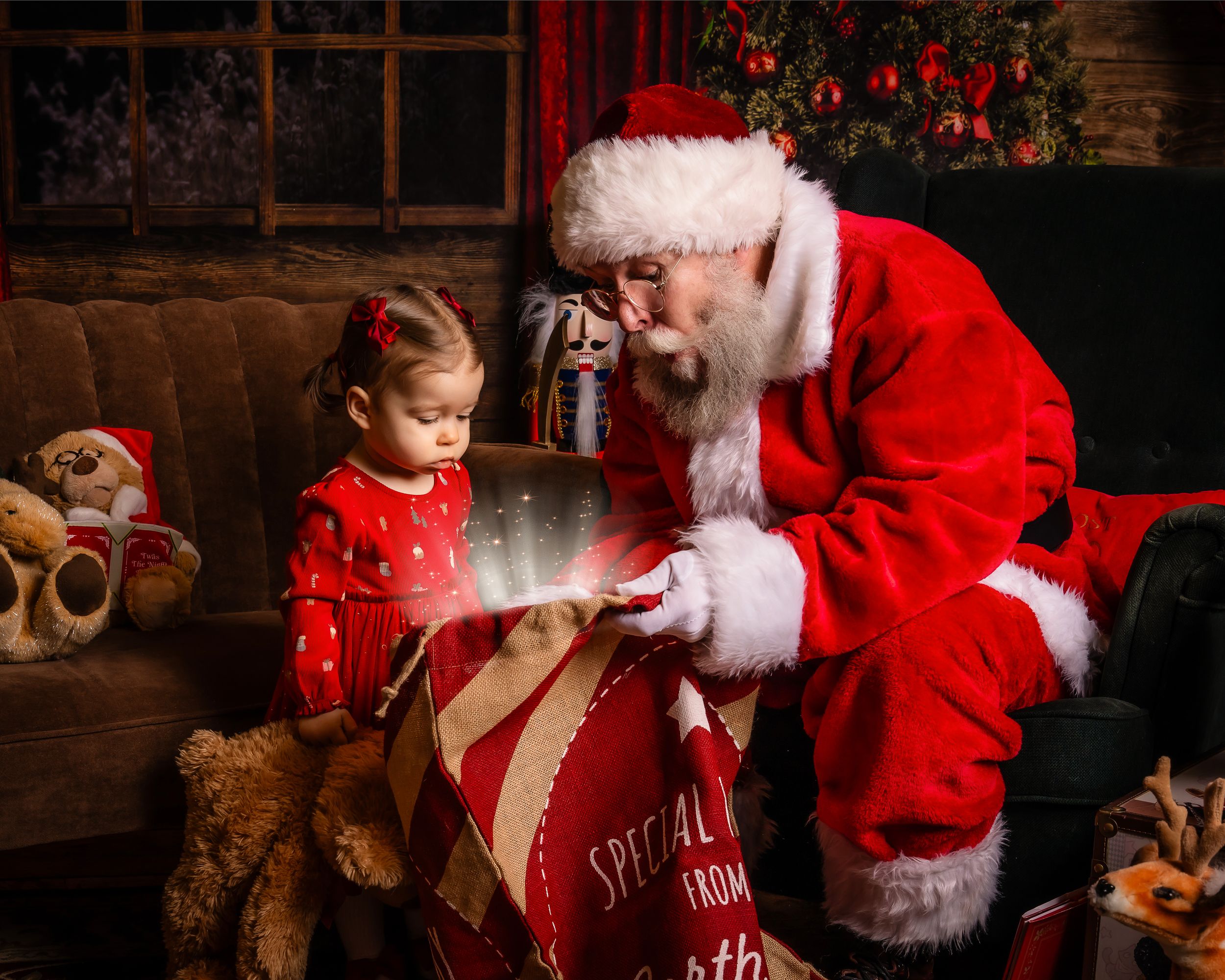 A magical Christmas scene with a figure in red showing a young girl in red dress a glowing gift sack among teddy bears.