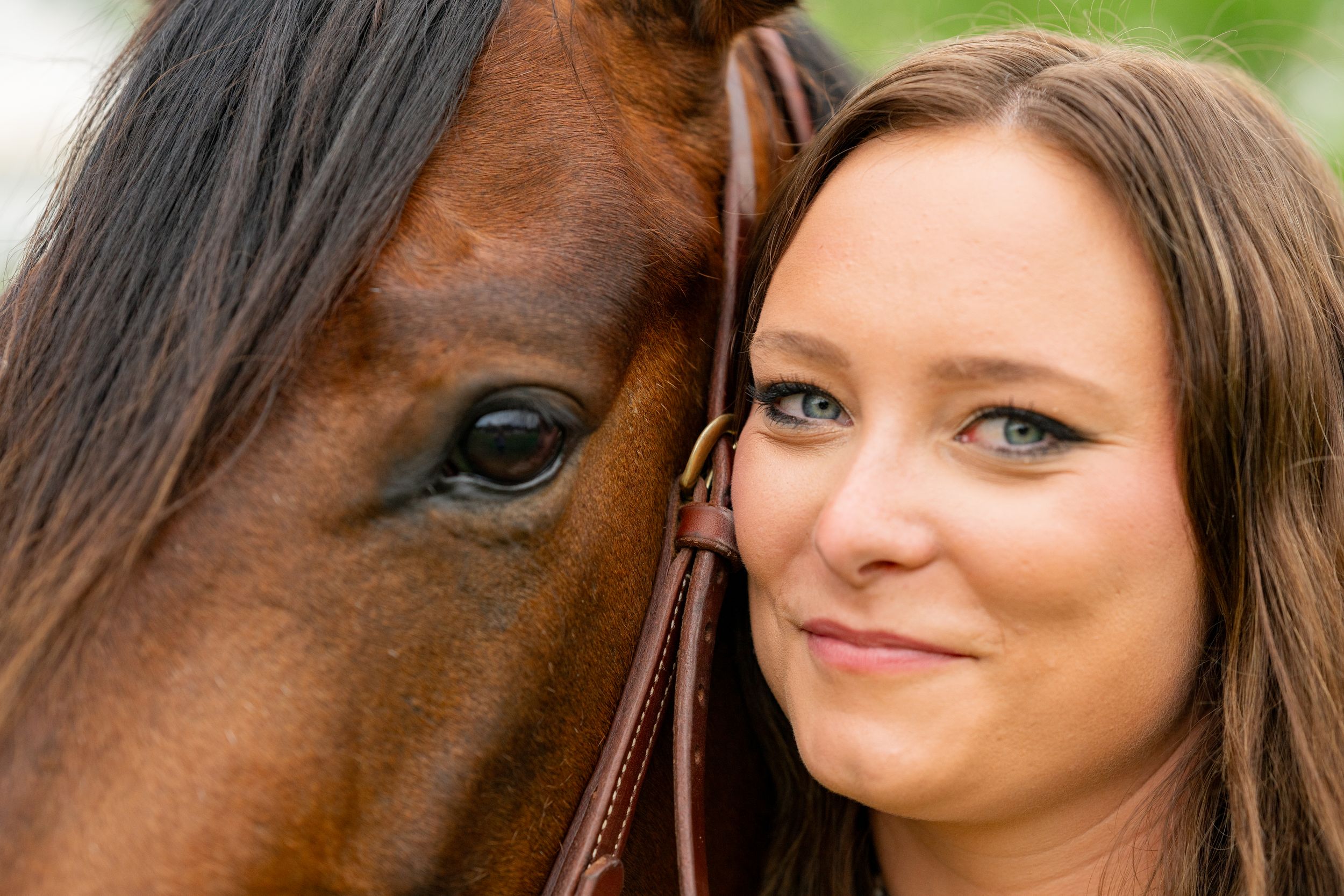 A close-up shot shows a horse's eye and face beside someone in an intimate portrait.