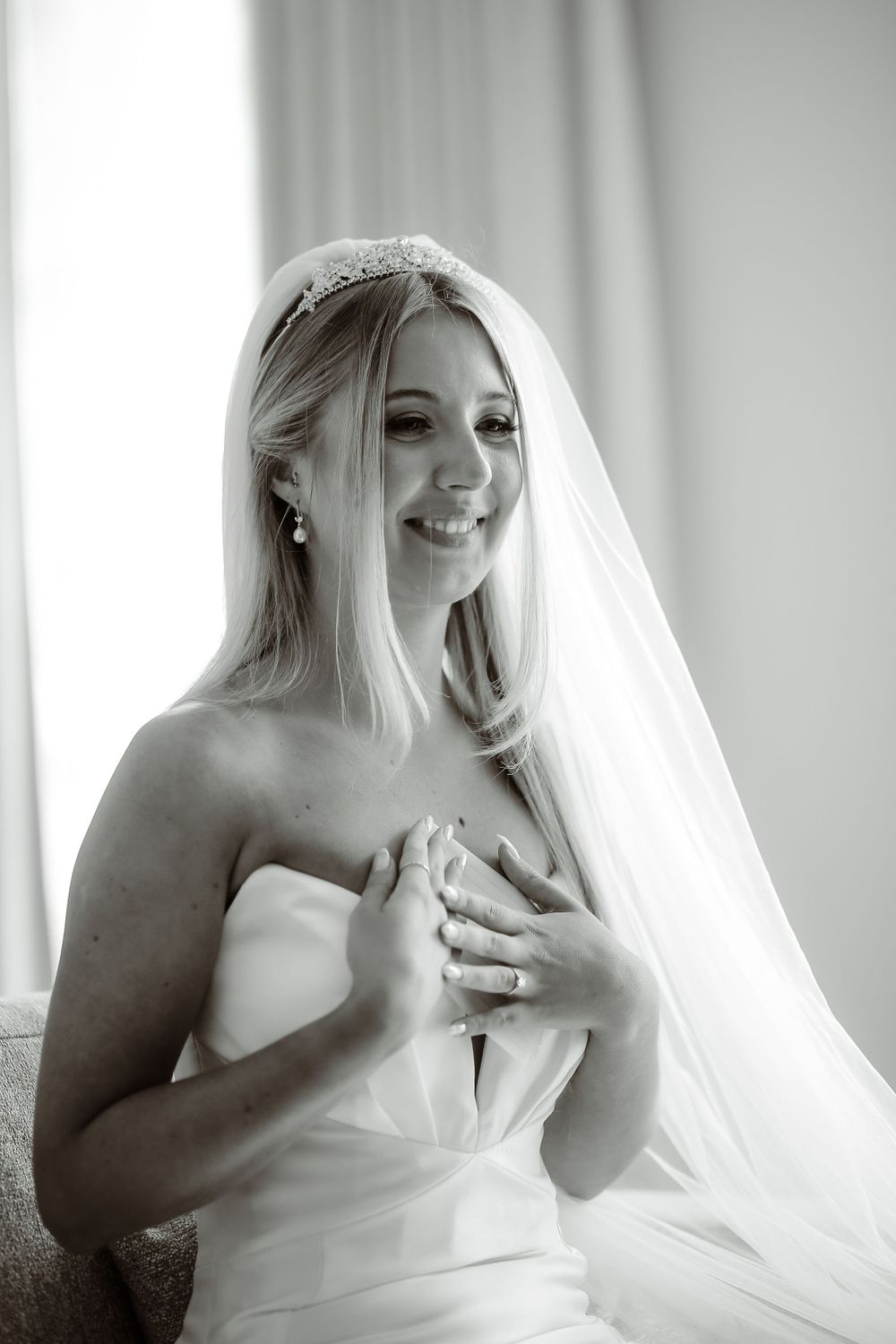 Black and white bridal portrait with flowing veil and emotional candid moment.