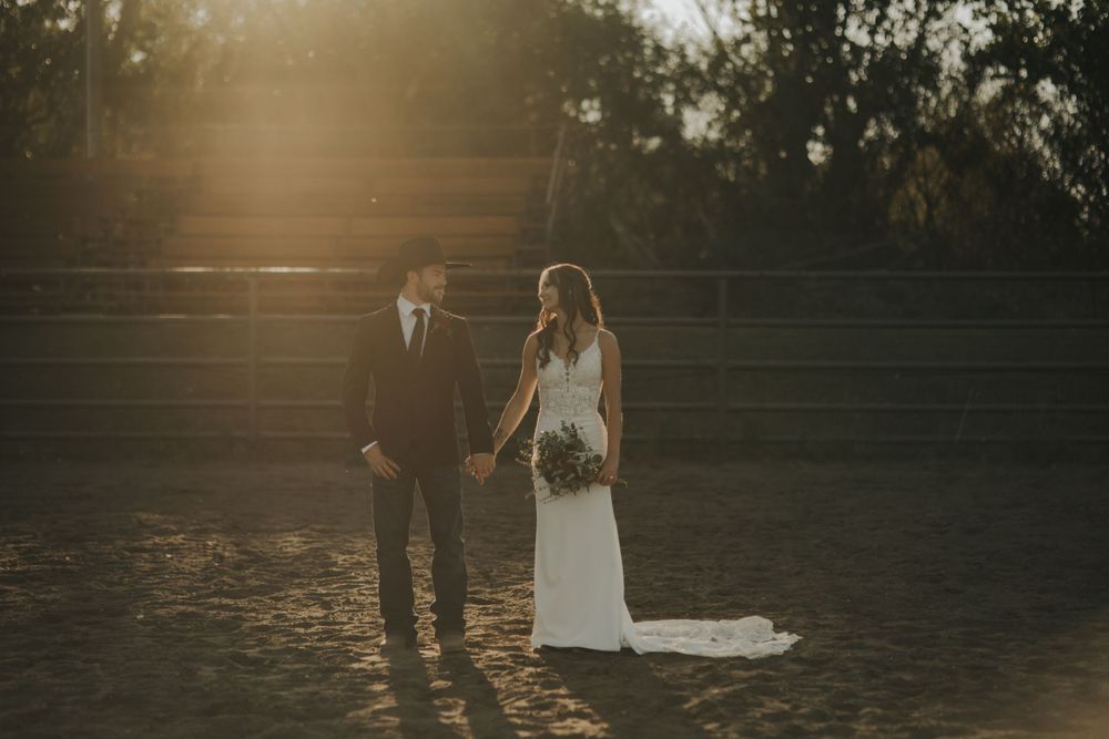 Newlyweds walking together during golden hour on their wedding day.