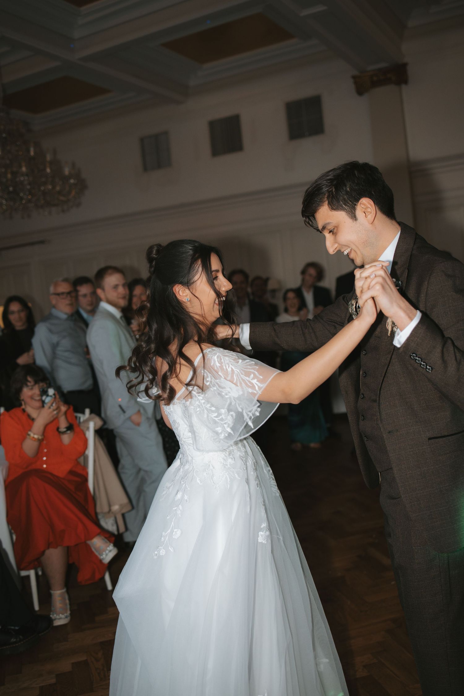 Couples dancing together at an elegant indoor wedding reception.
