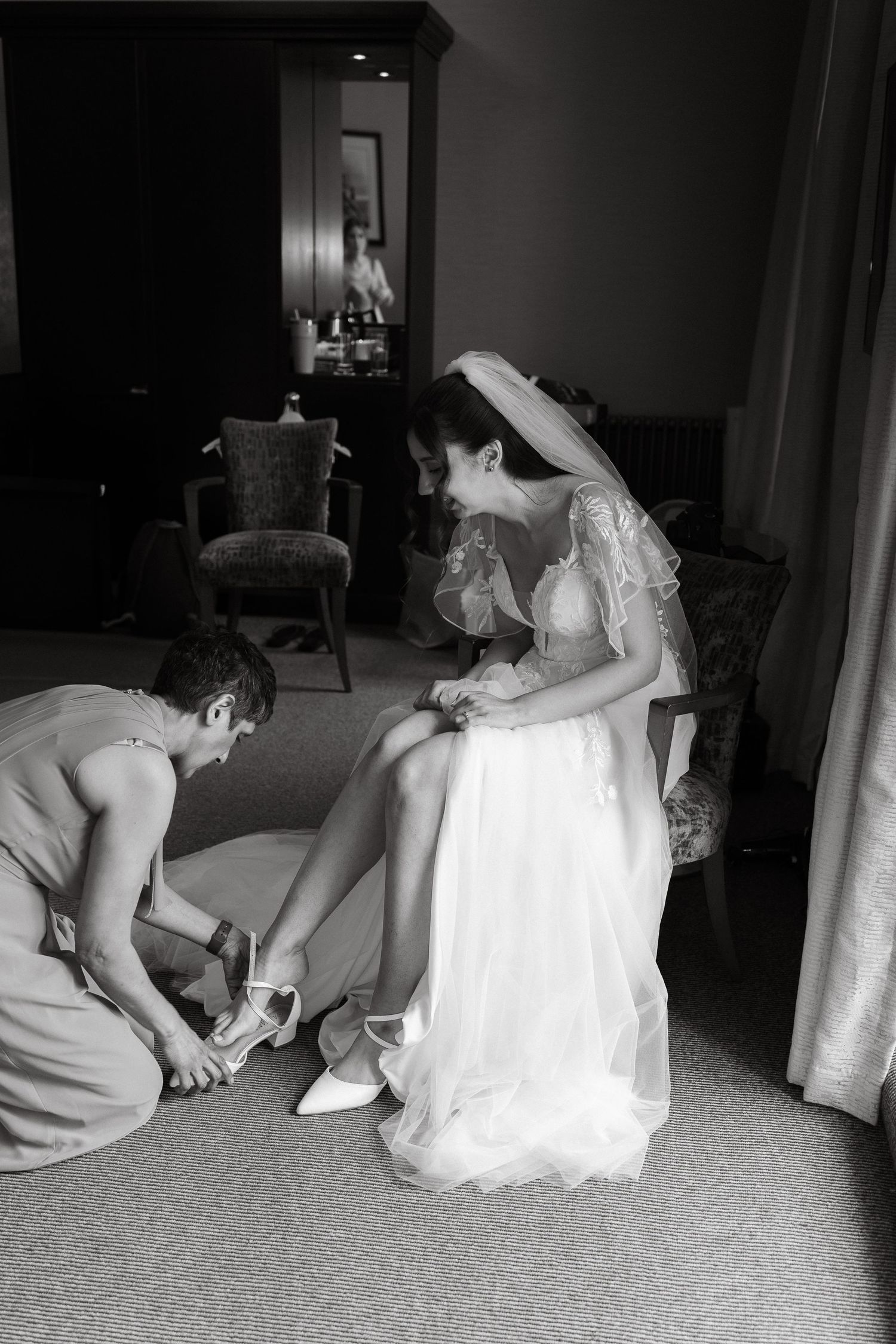 Black and white sequence of wedding dress fitting and adjustments.