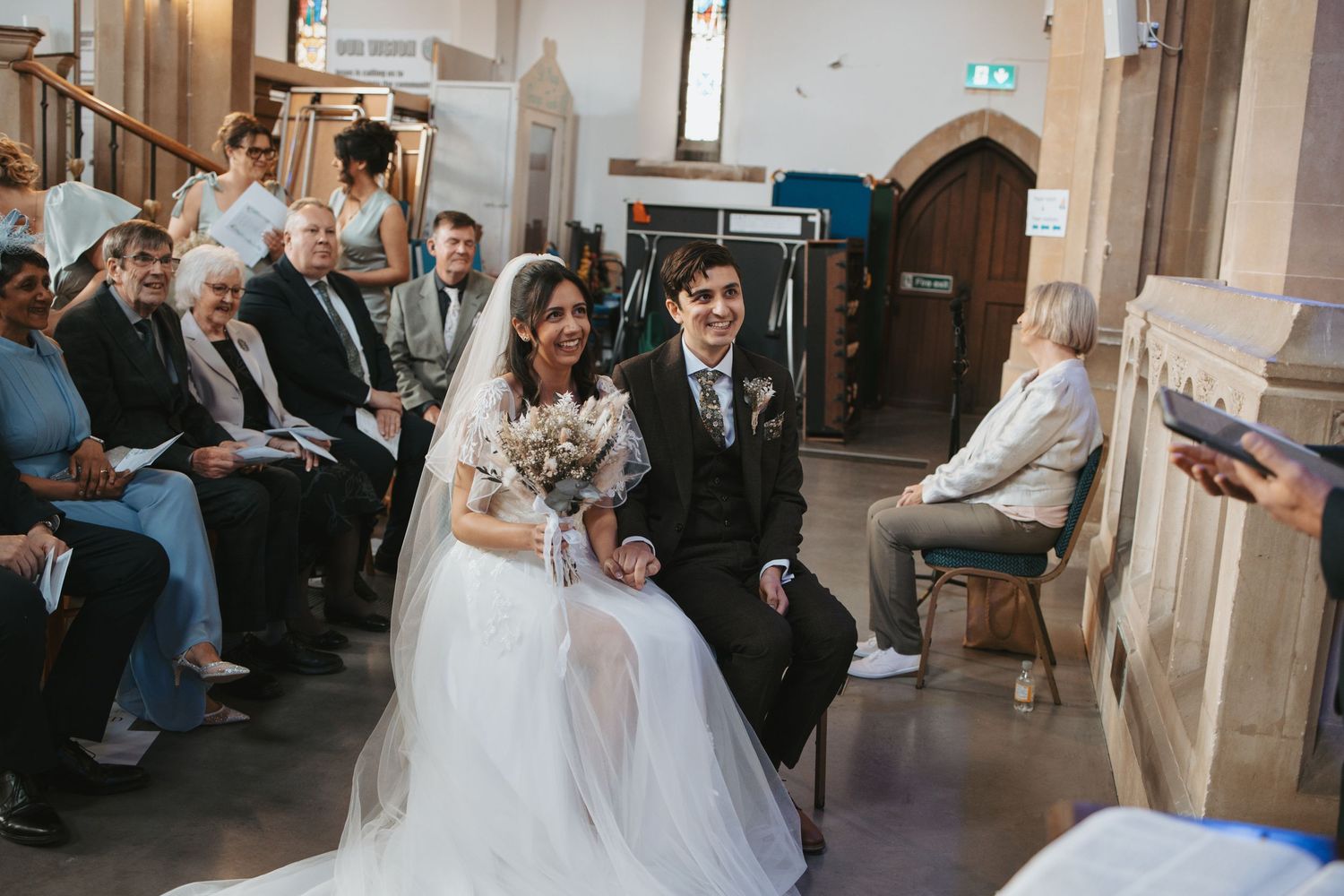 A joyful recessional down the church aisle after a wedding ceremony.