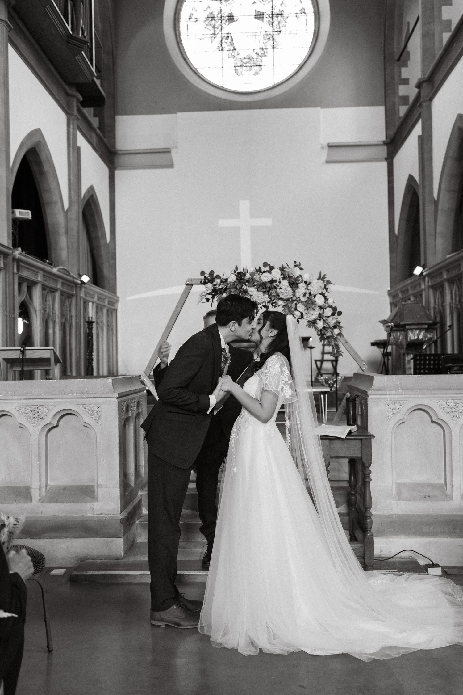 Elegant wedding dance sequence in a grand church with arched ceilings and circular windows.