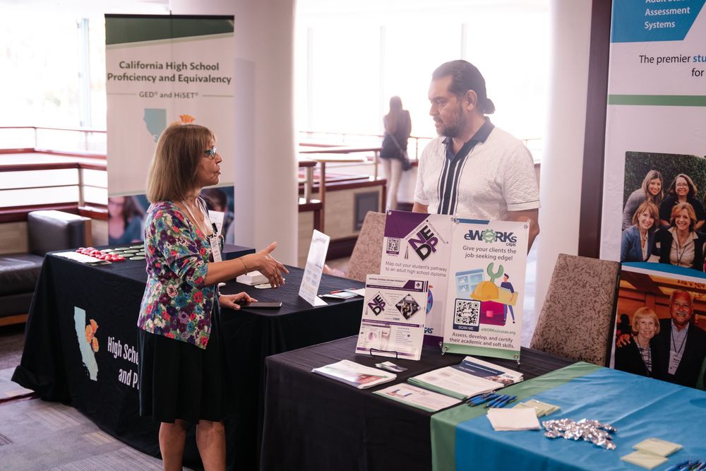 A sequence of business professionals interacting at exhibition booths during a networking or trade show event.