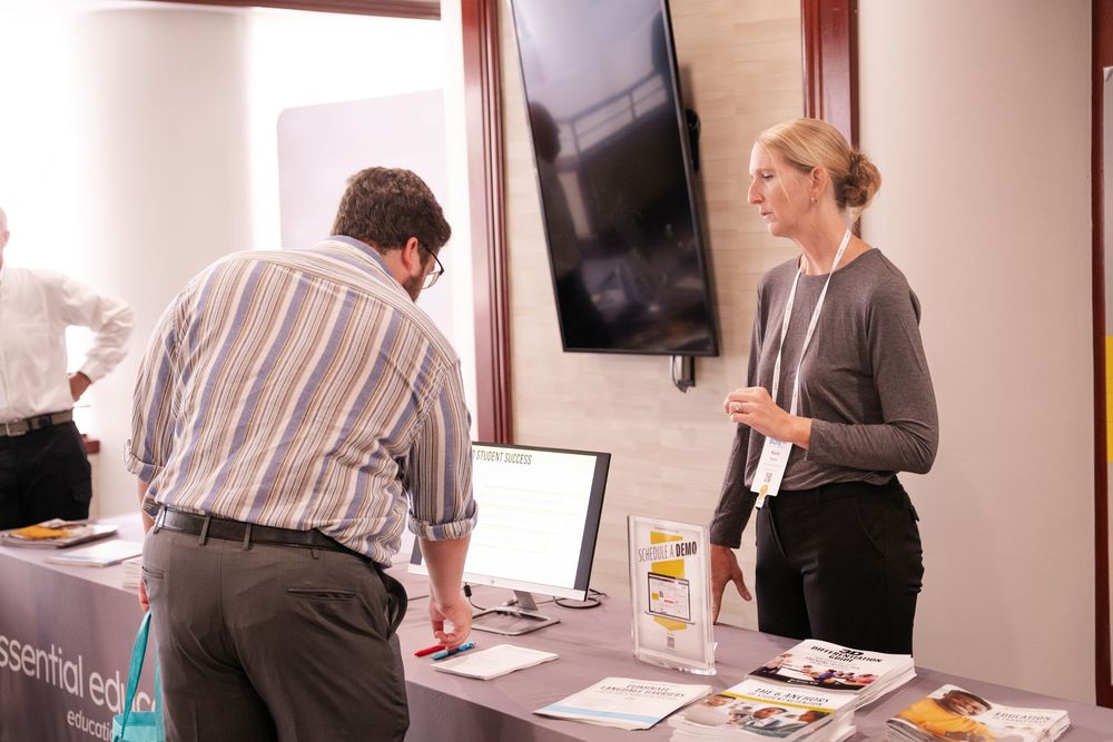 Business professionals collaborate at a conference table during a meeting in a modern office setting.