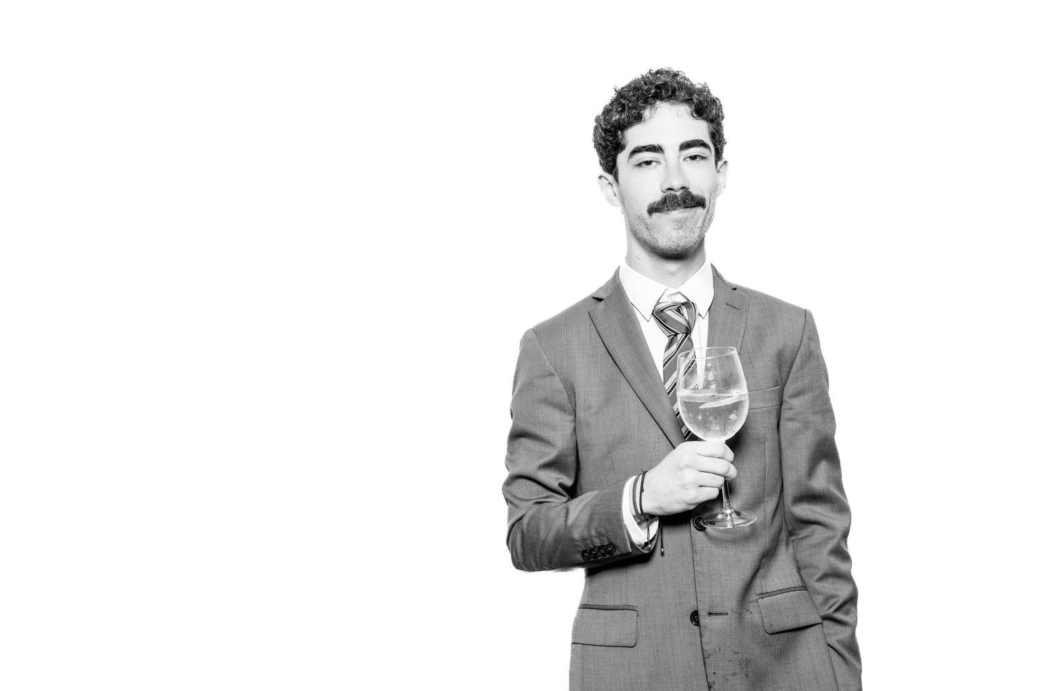 Black and white portrait series of a person in formal attire making expressive gestures.